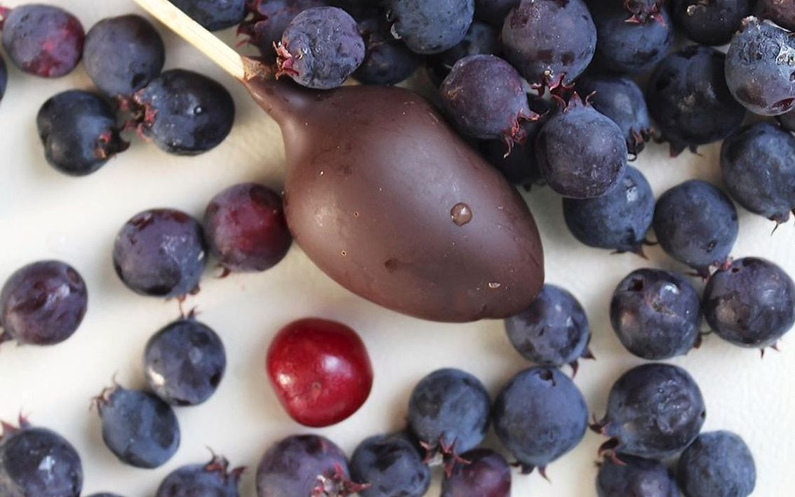 A dark chocolate shell filled with raspberry liqueur, cut in half
